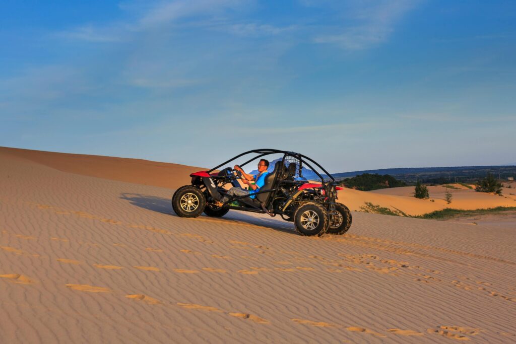 Experience thrilling off-road adventure driving a dune buggy across desert sands.