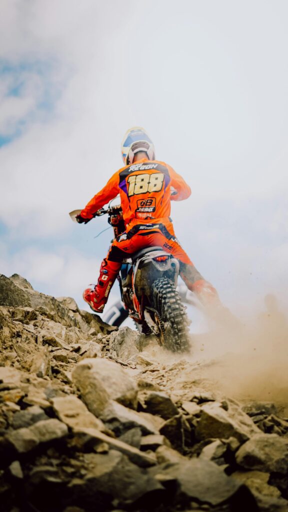 A thrilling scene of motocross racing on rocky terrain in Indonesia.