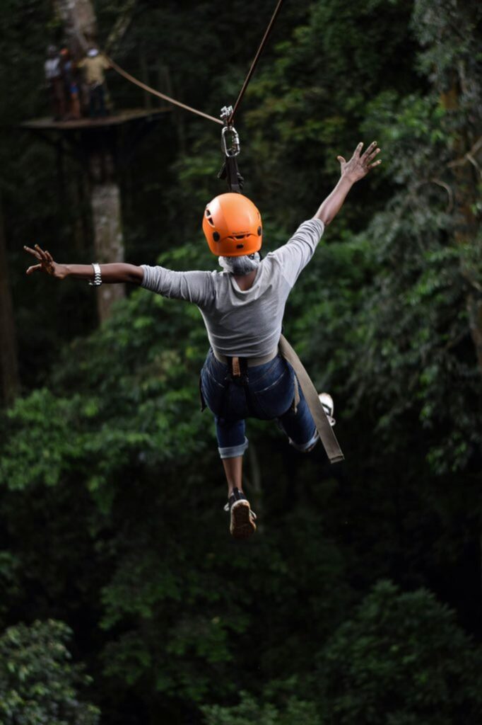 Experience the thrill of ziplining through Uganda's lush forests with this adventurous capture.
